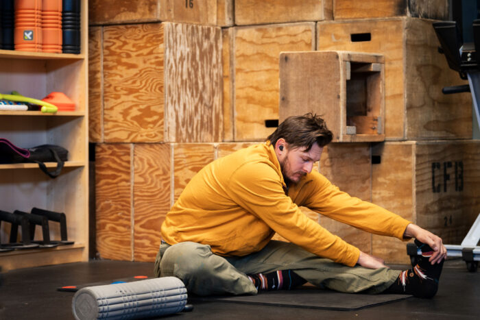Man in gym stretching