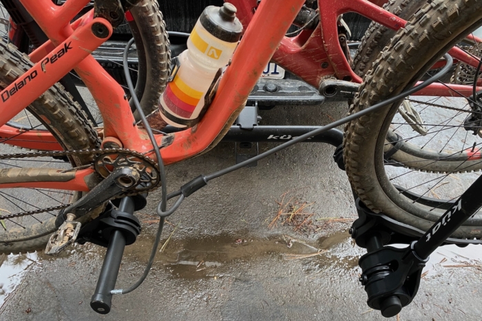 2 mountain bikes locked on the Kuat Transfer with the included cable lock