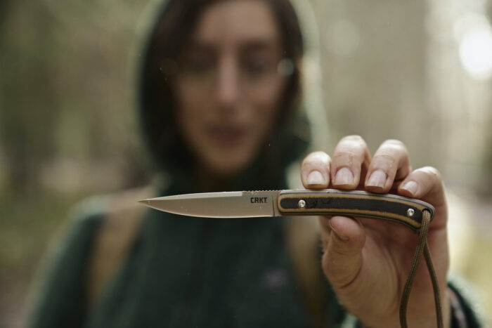 a woman holds the CRKT Biwa knife