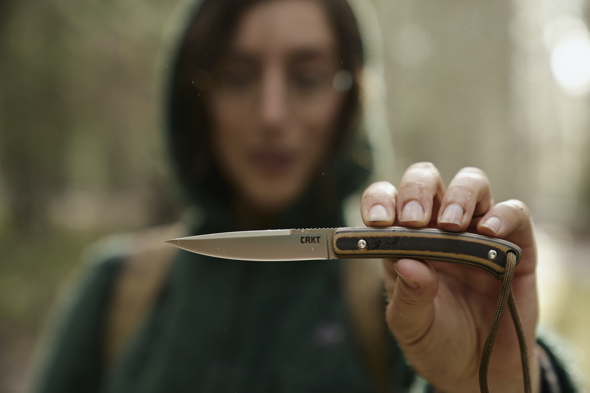 a woman holds the CRKT Biwa knife