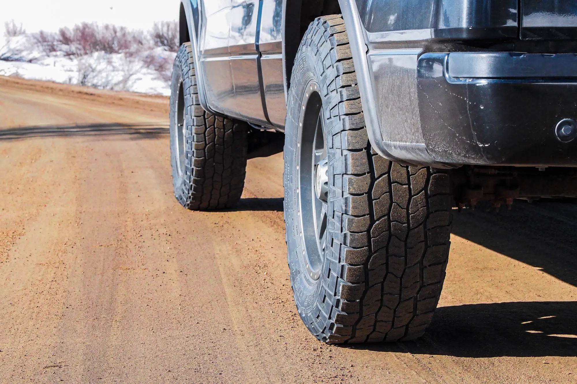 Cooper Discover AT3 XLT tires on muddy road