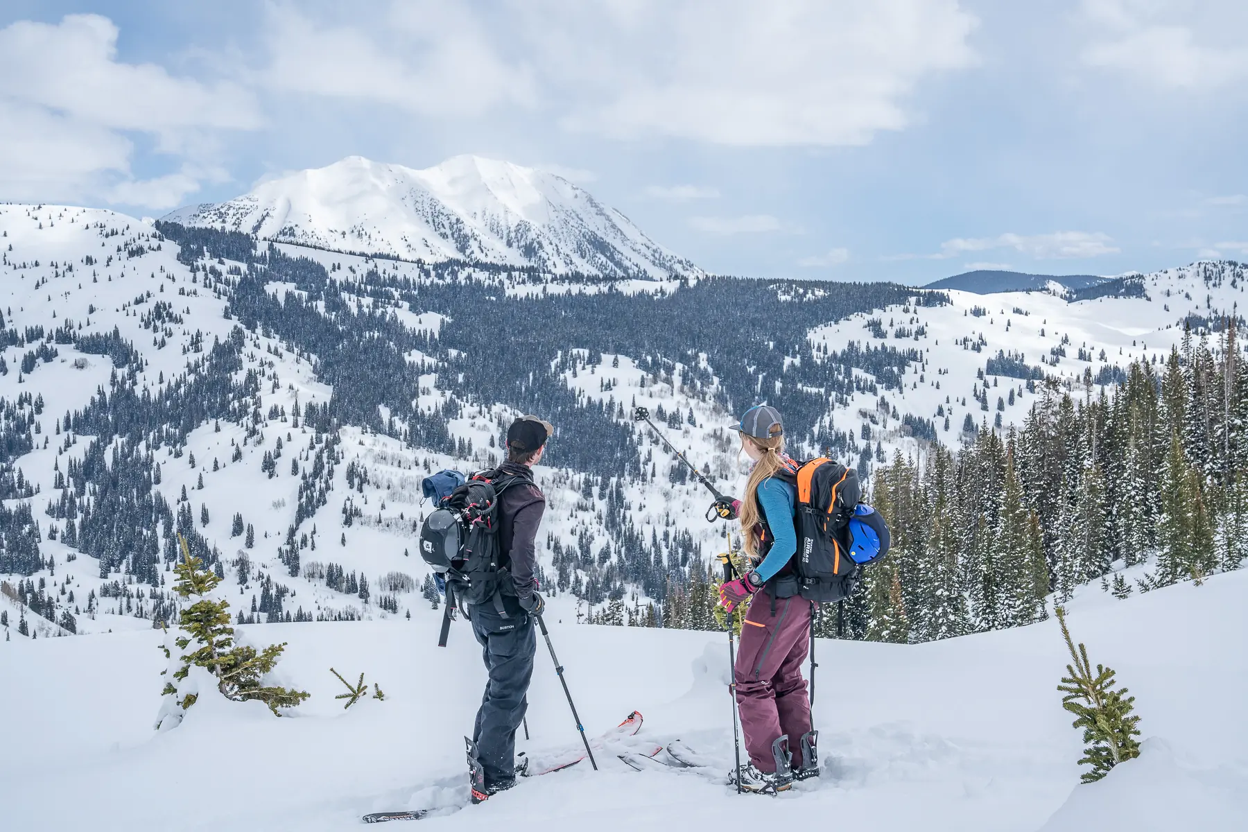 two splitboarders looking at mountain view