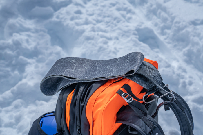 splitboarding skins on top of backpack 