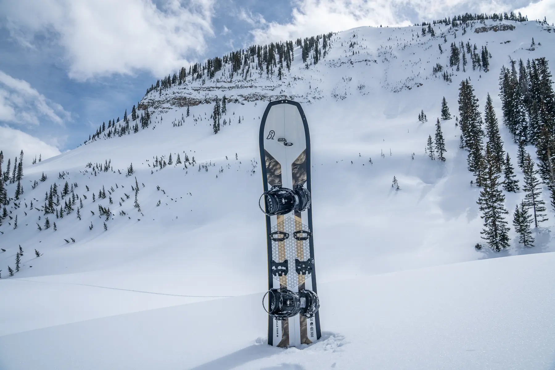 splitboard set in snow with mountain backdrop