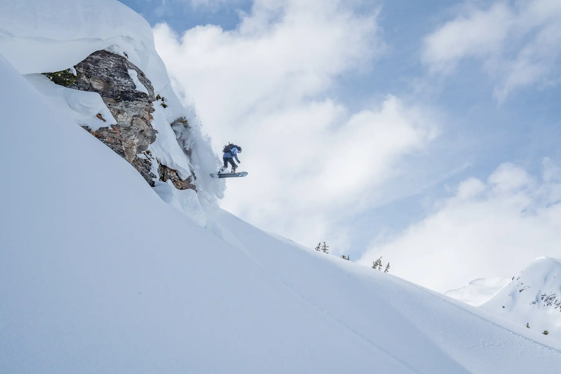 splitboarder hitting a cliff drop