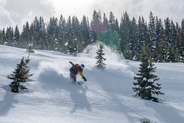 splitboarder descending through deep snow 