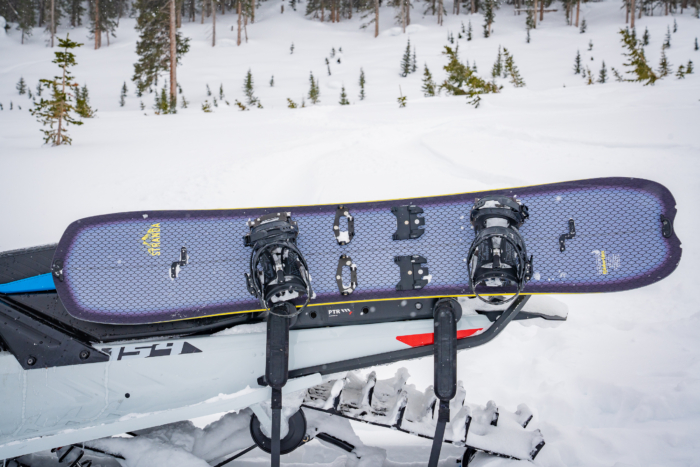 splitboard sitting in rack on snowmobile 