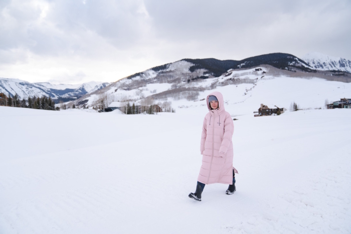 woman walking outside on a snowy landscape in the Columbia Pike Lake II Long