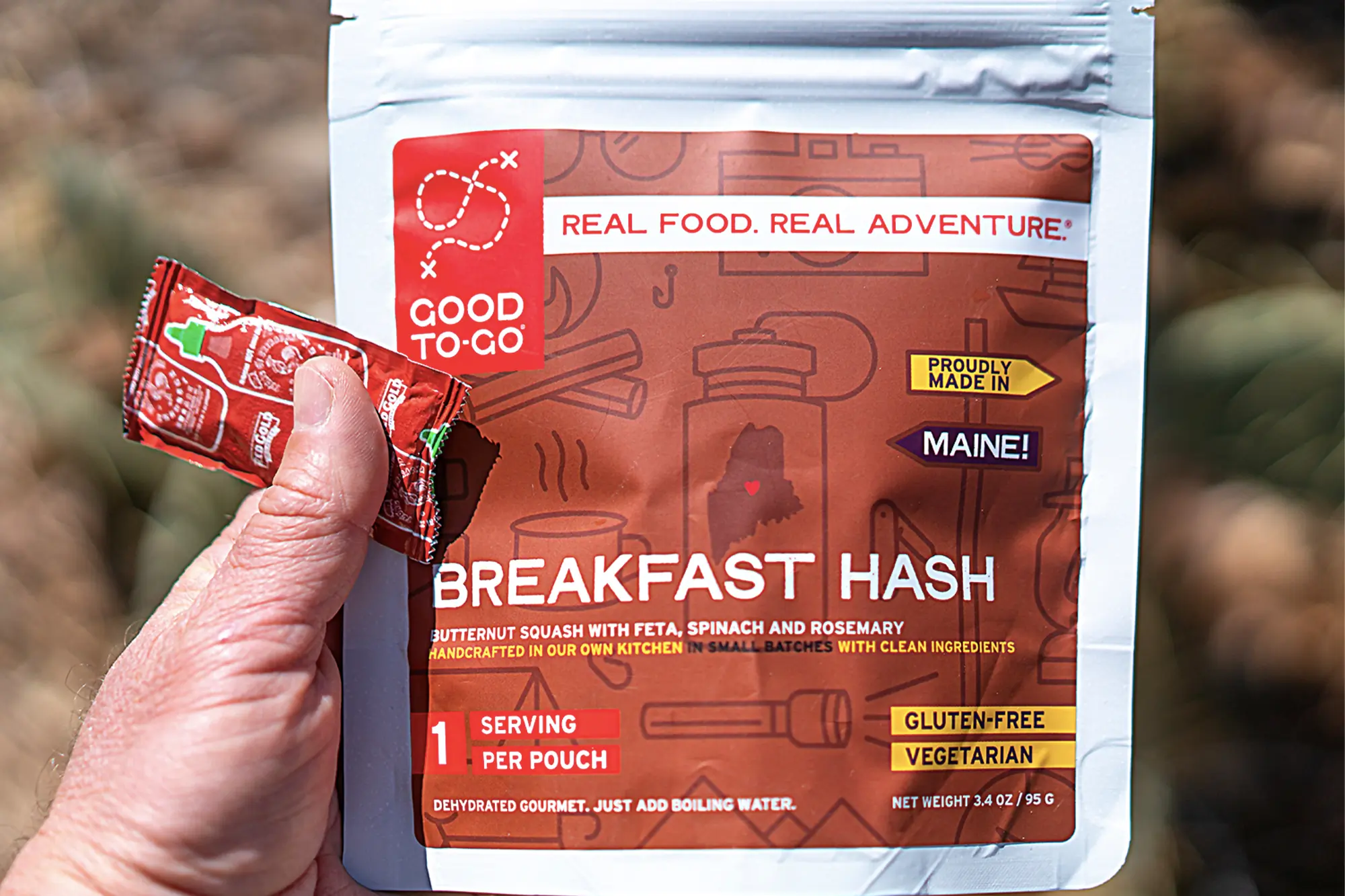 person holding good to go larese gluten free camping meal in hand