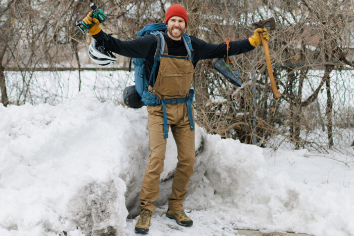 man wearing overalls with tools and gear