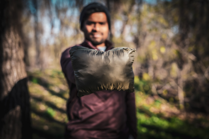 man holding patagonia fitz roy nano puff hoody in a pouch