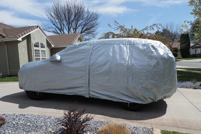 car cover on a vehicle in a driveway 