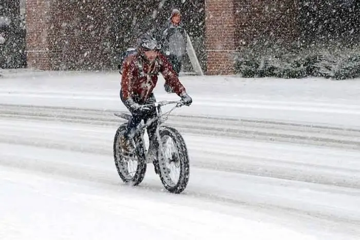 Riding a fat bike on snow covered roads during a snow storm