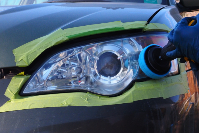 taped off headlight being buffed down 