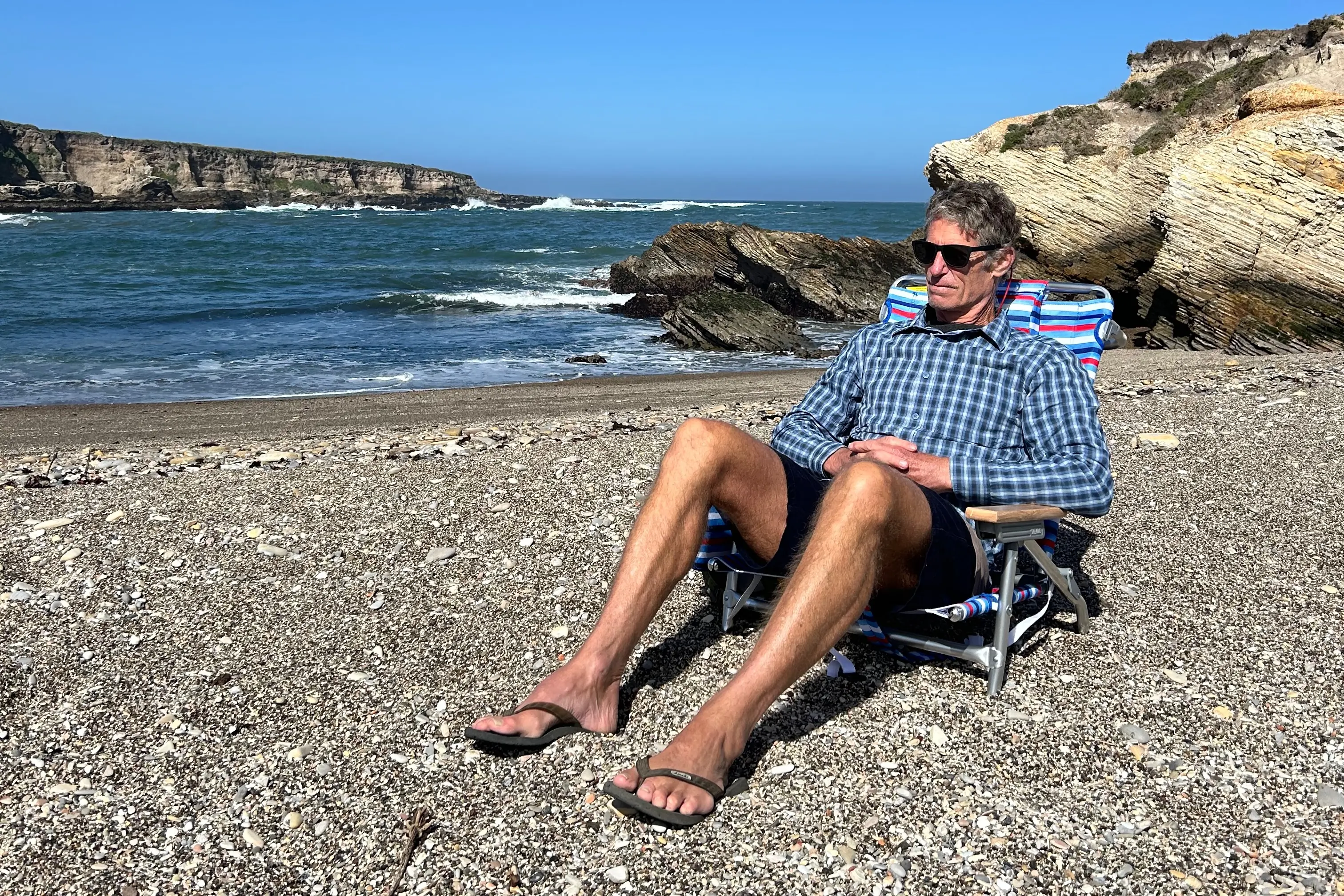 Sitting in the Tommy Bahama Backpack Beach Chair at a beach on the California Coast