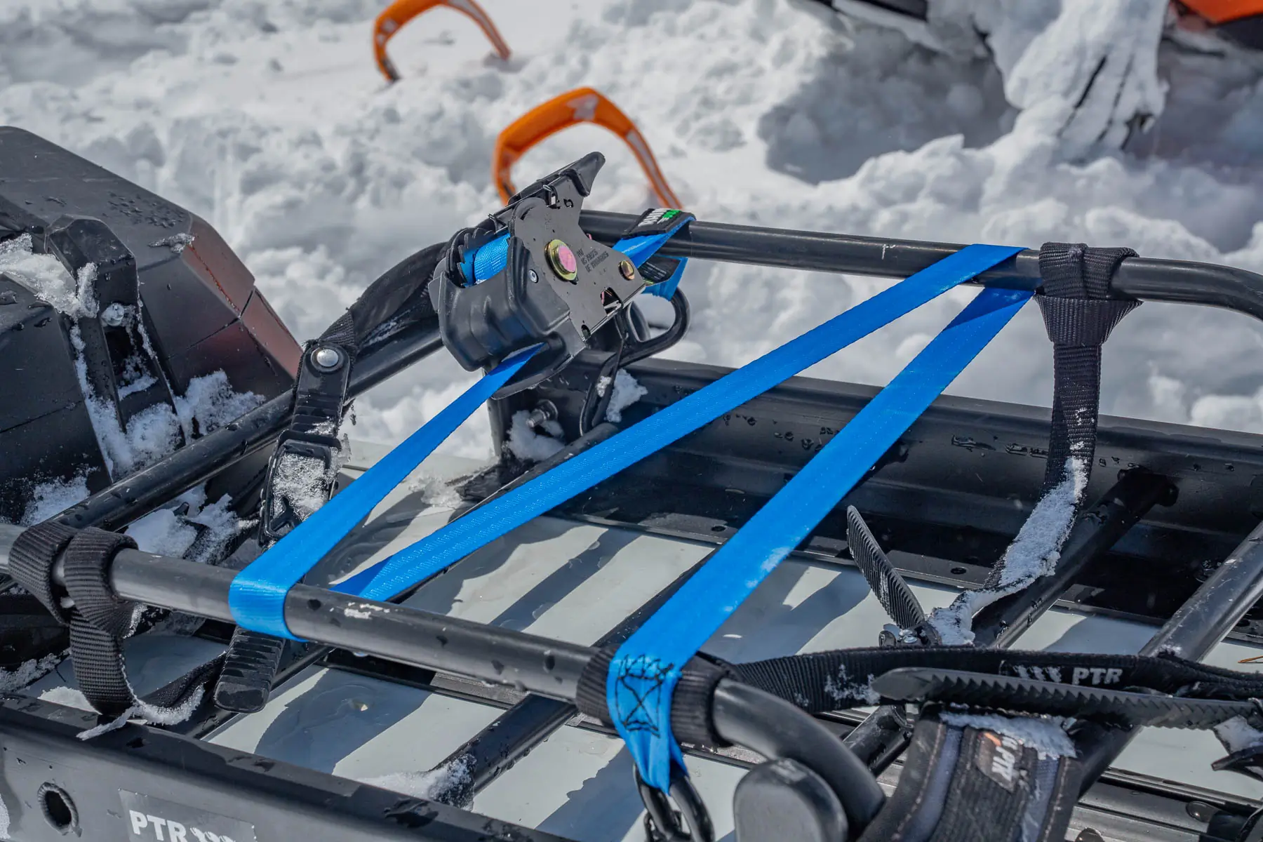 Rhino Rack Retractable Ratchet Straps on a snowmobile rack 