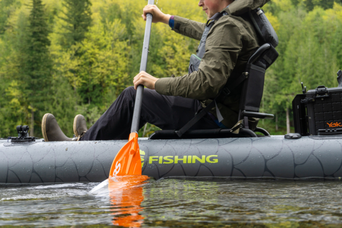 A fisherman paddles the NRS Ripple paddle in their NRS Pike inflatable kayak