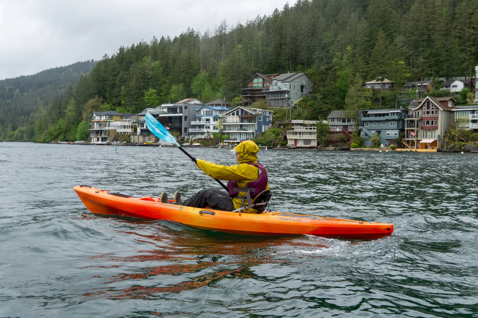 a paddler uses a sit-on-top kayak in a Canadian lake