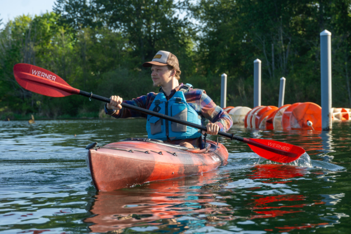 a kayaker paddling the Old Town Loon near shore