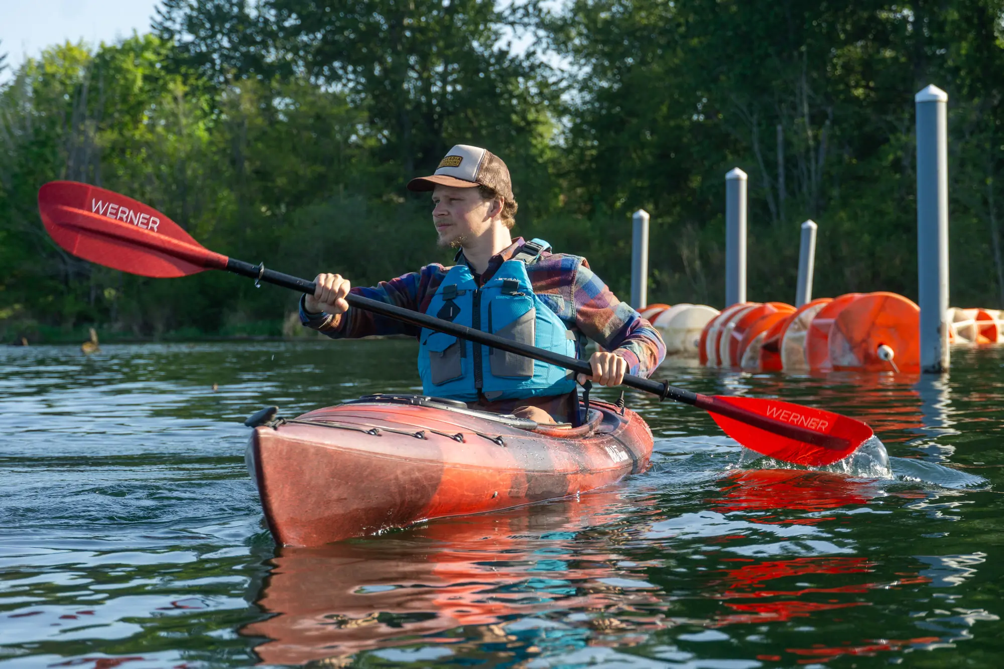 a kayaker paddling the Old Town Loon near shore