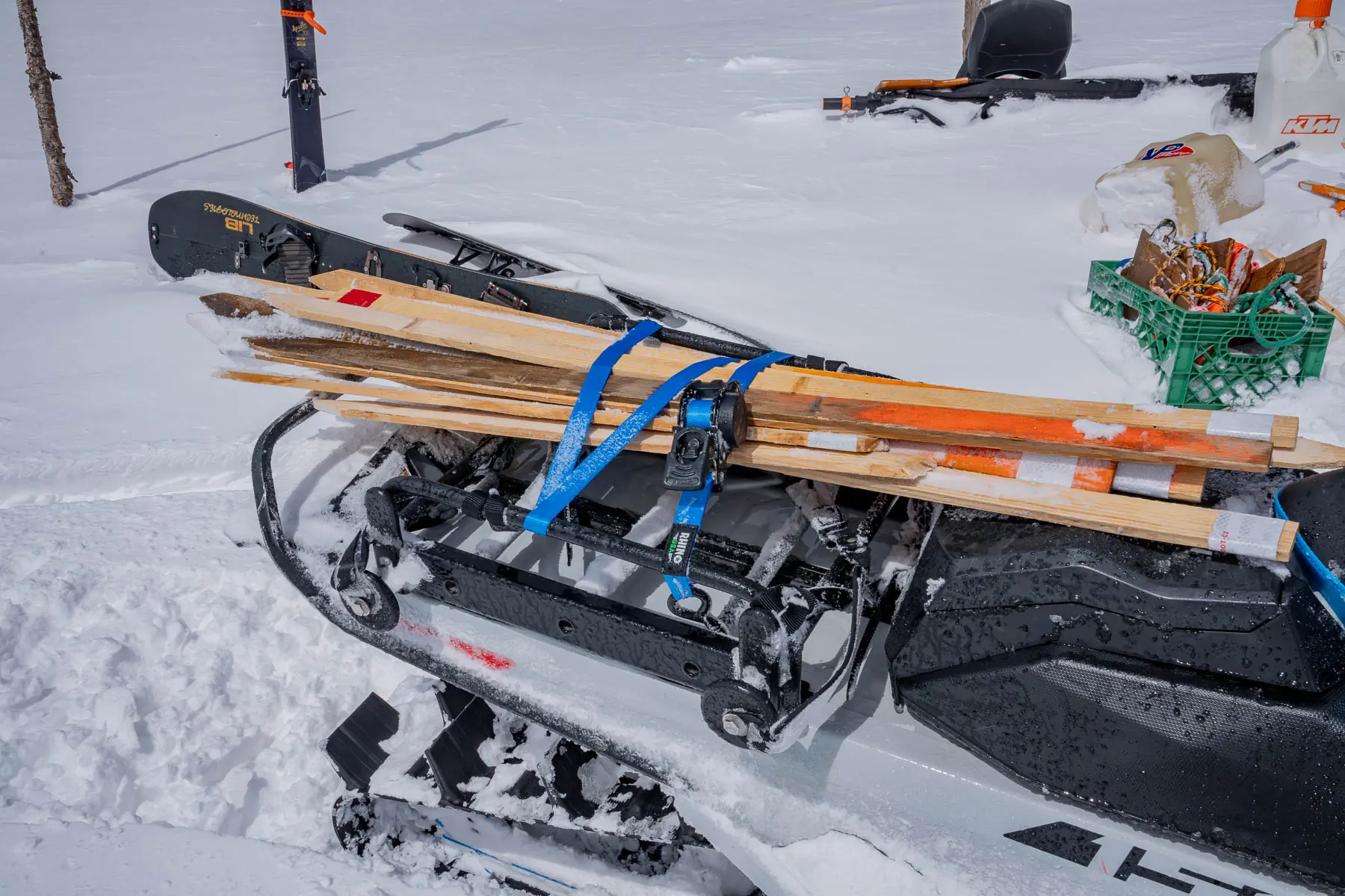 ratchet straps holding down markers on snowmobile rack 