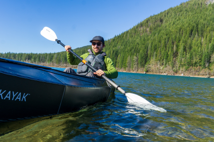 A kayaker paddles with a low-angle paddle stroke