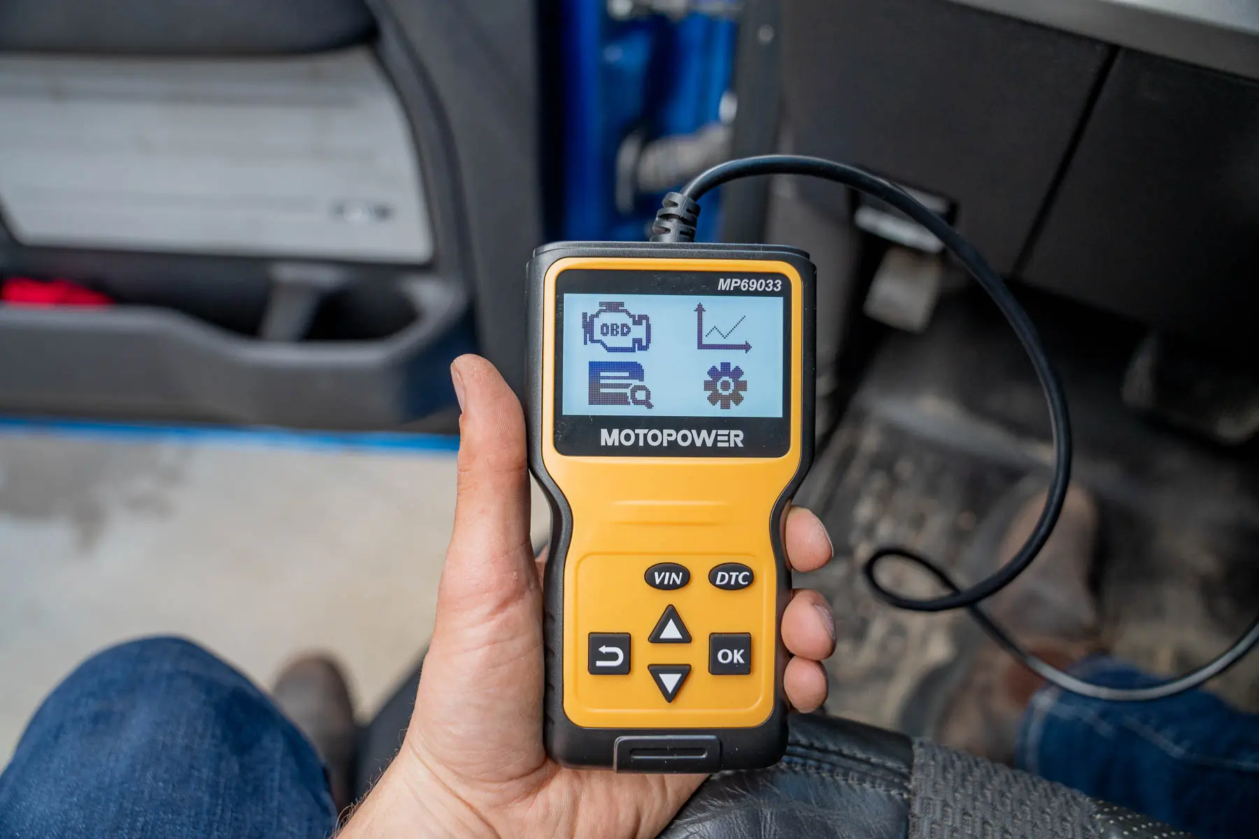 person holding OBD2 scanner