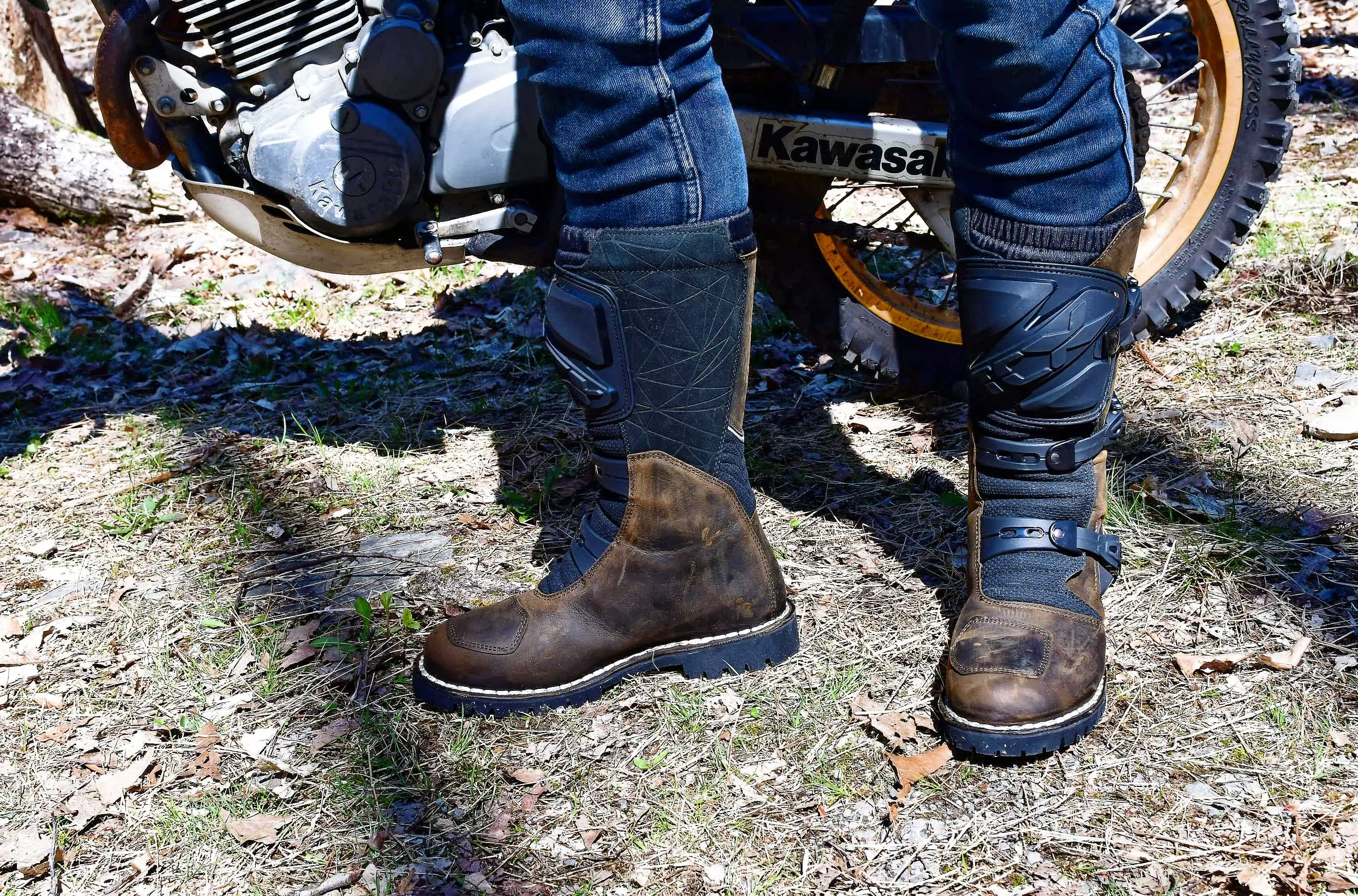 motorcyclist standing next to a bike