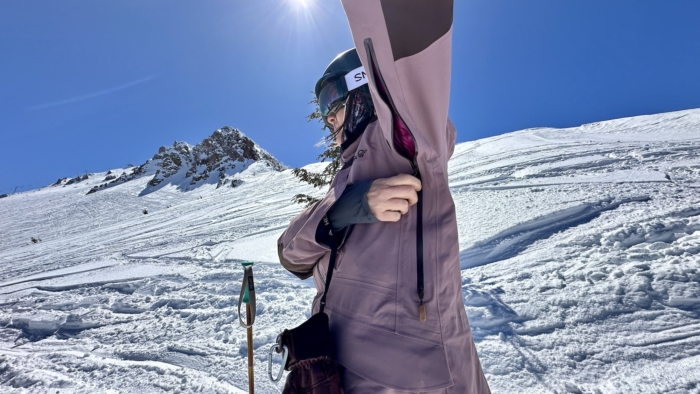 woman showing extra long pit zips on norrøna tamok gore-tex performance shell jacket