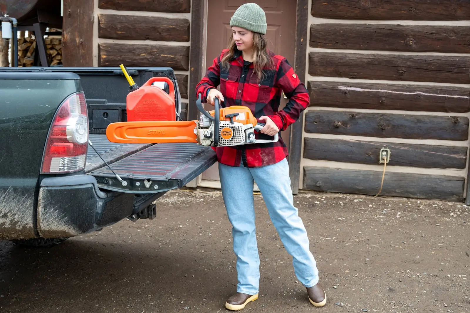woman wearing flannel at pickup truck bed