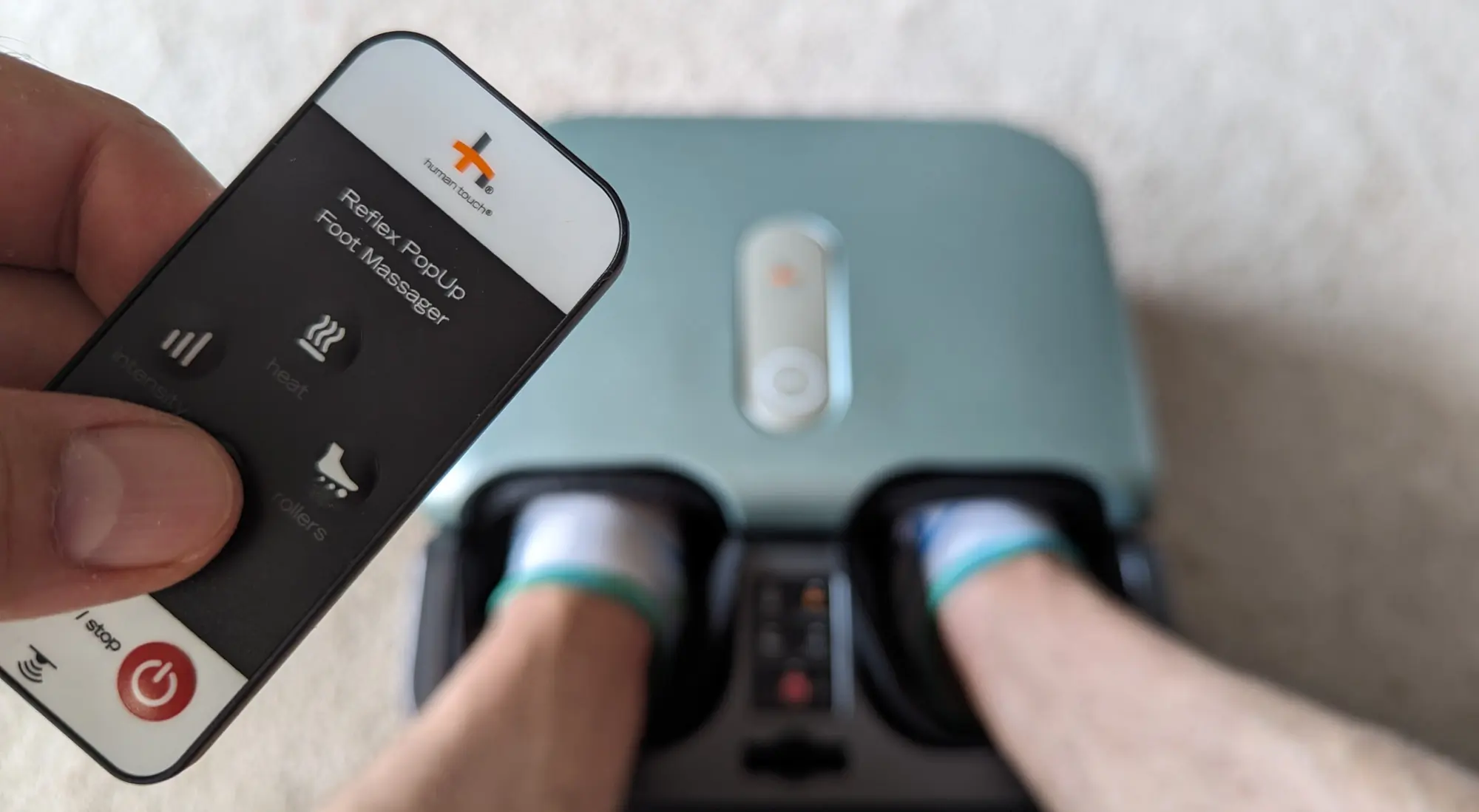 Gear Junkie - Best Foot Massagers - Humantouch Reflex PopUp with remote in hand