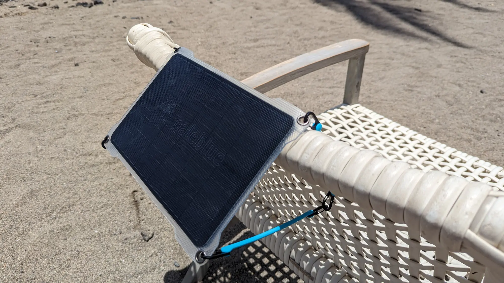 Gear Junkie - Best Portable Solar Charger - Pale Blue Earth solar panel attached to a chair.