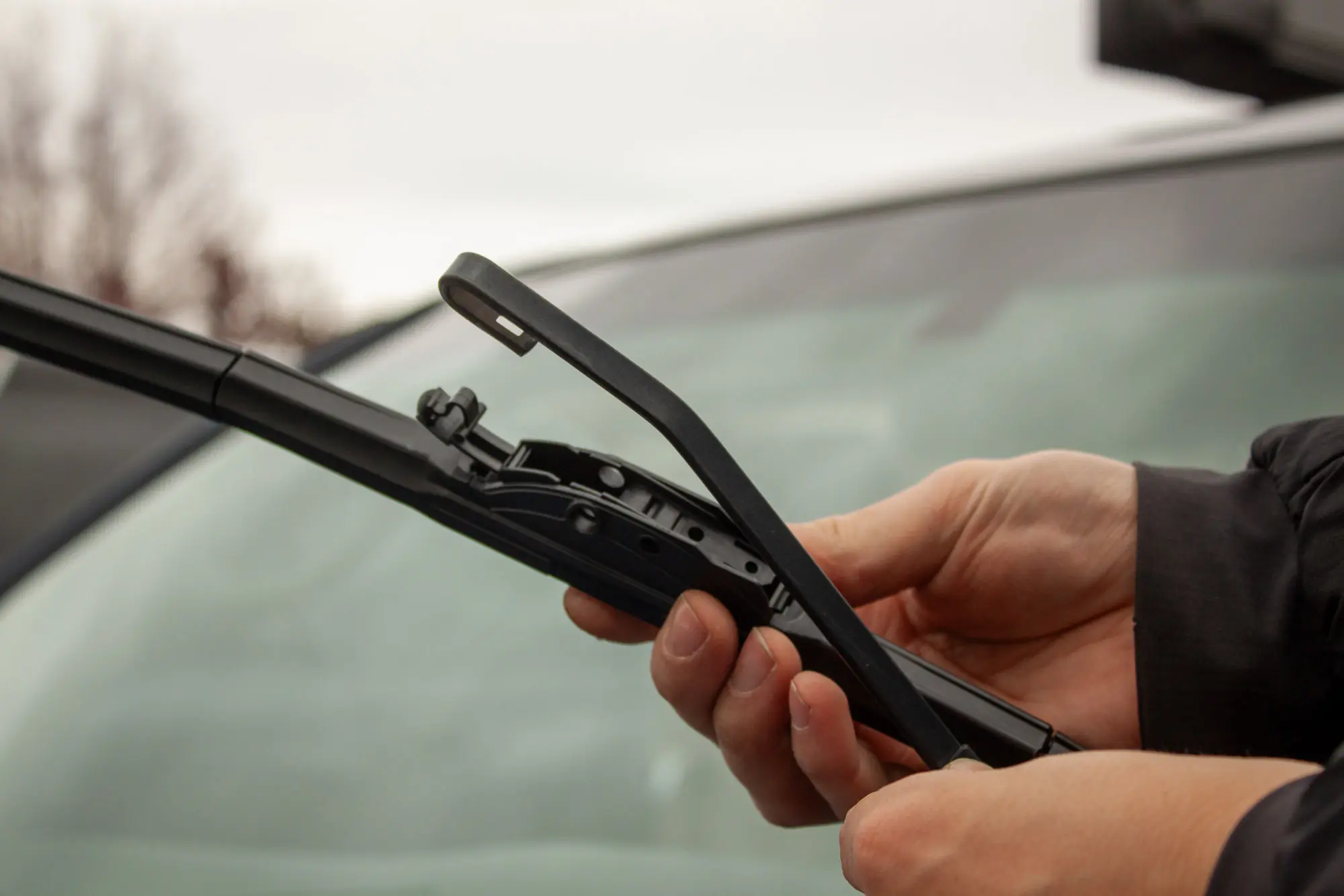 a set of hands replaces a wiper blade by attaching it to the wiper arm