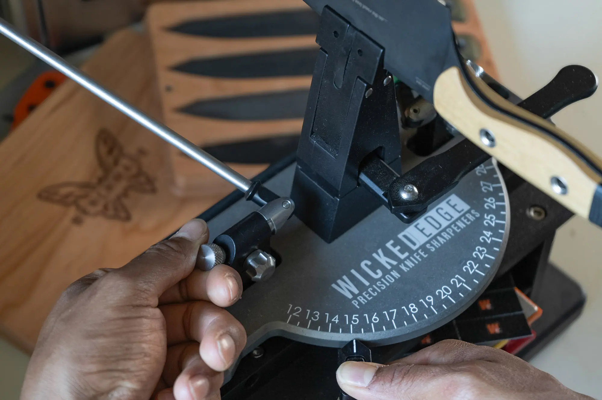 A set of hands adjusts the angle of the grind using both the base unit and Micro-Adjust arms