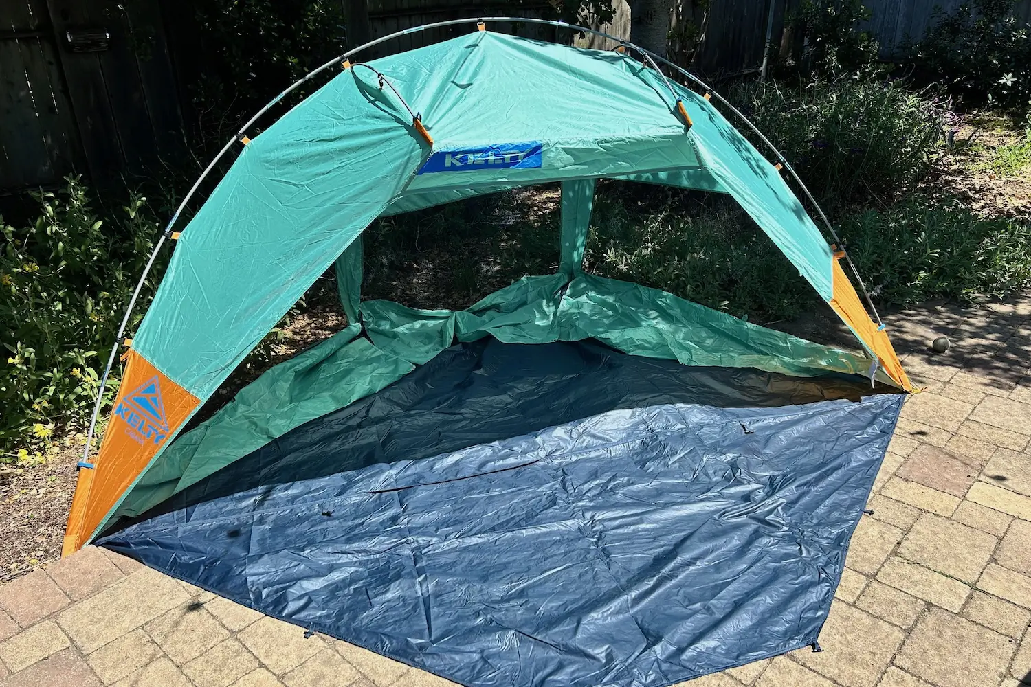 The Kelty Cabana beach tent set up in a backyard