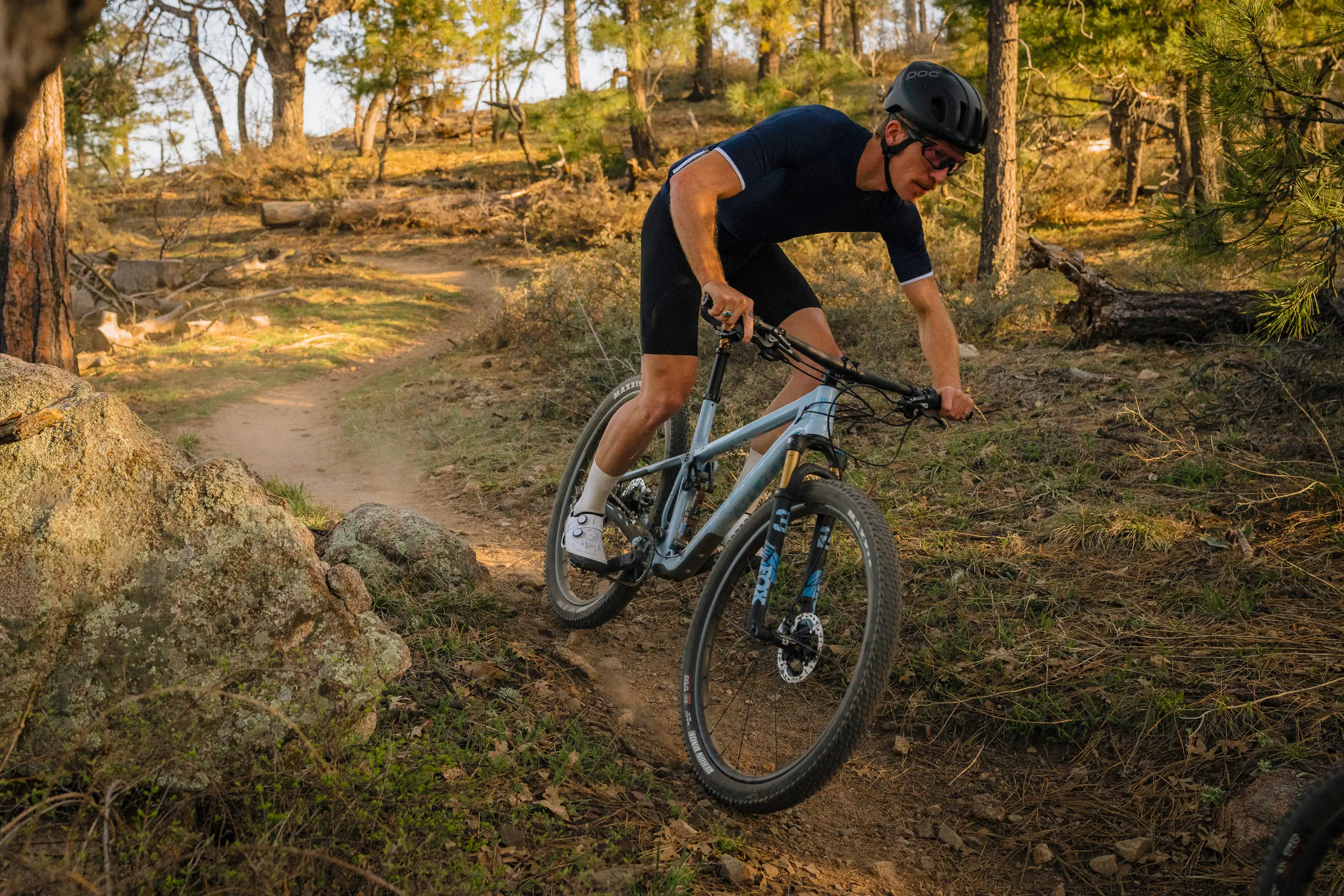 A man on the brakes on a 2023 Pivot Mach 4 SL