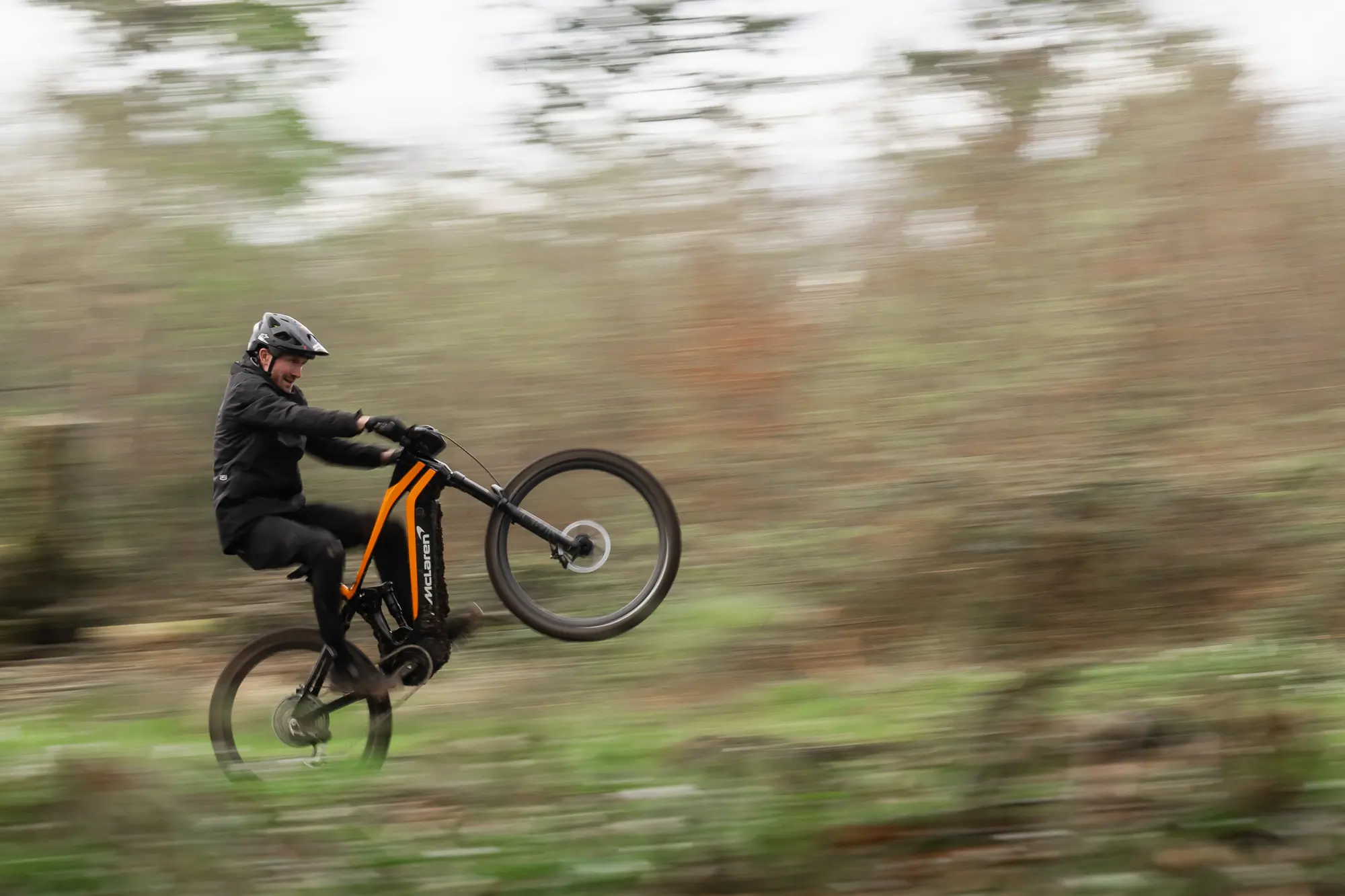 Rider wheelie on McClaren electric mountain bike