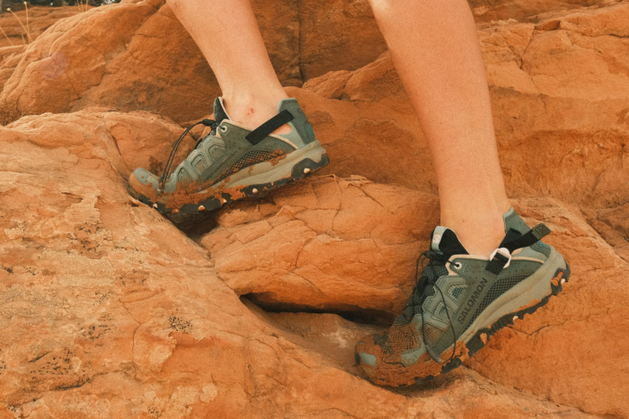 Salomon Techamphibian 5 with a little bit of dirt on it against red rocks.