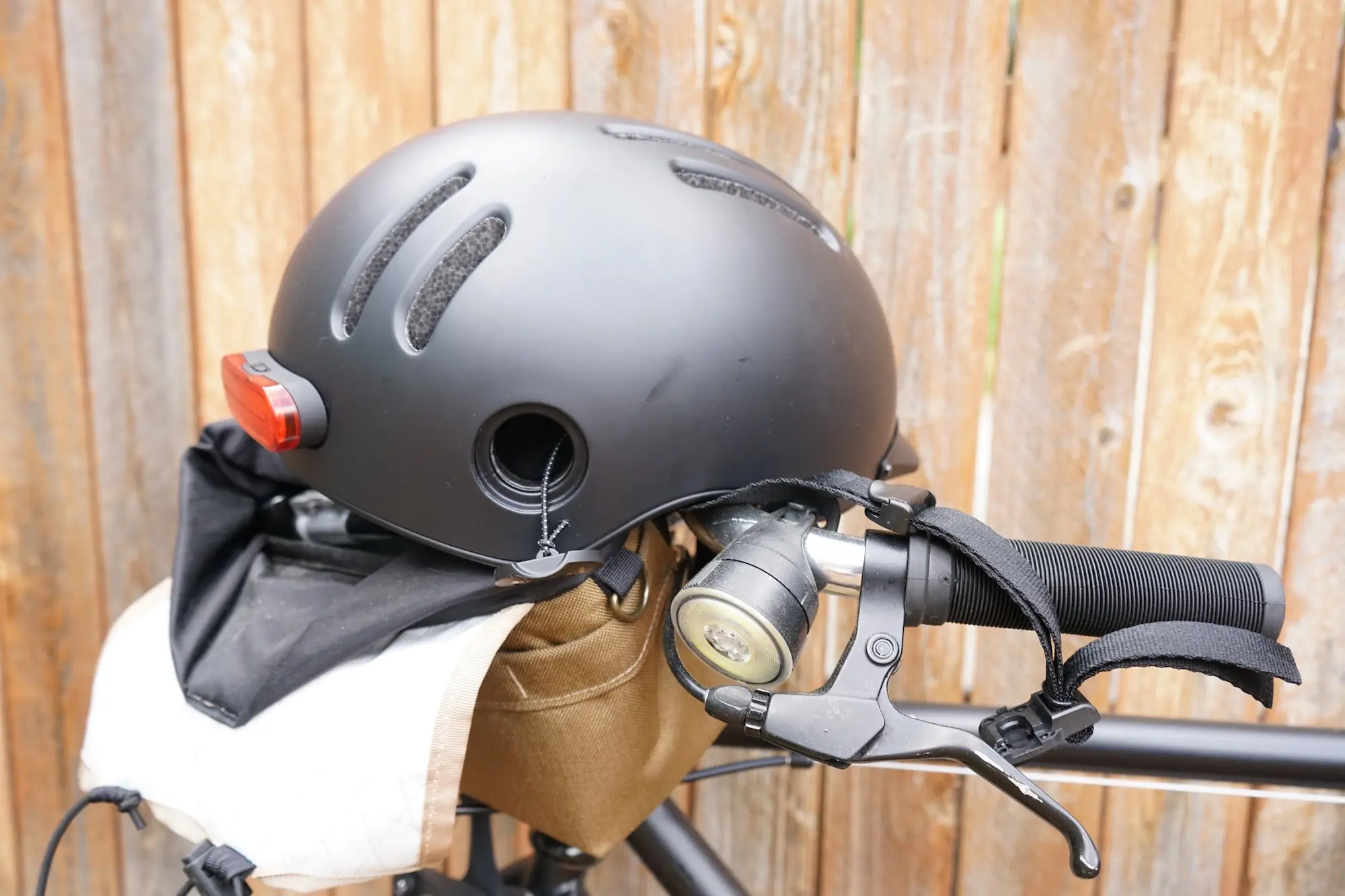 The Thousand Chapter MIPS commuter helmet sitting on a commuter bike handlebar