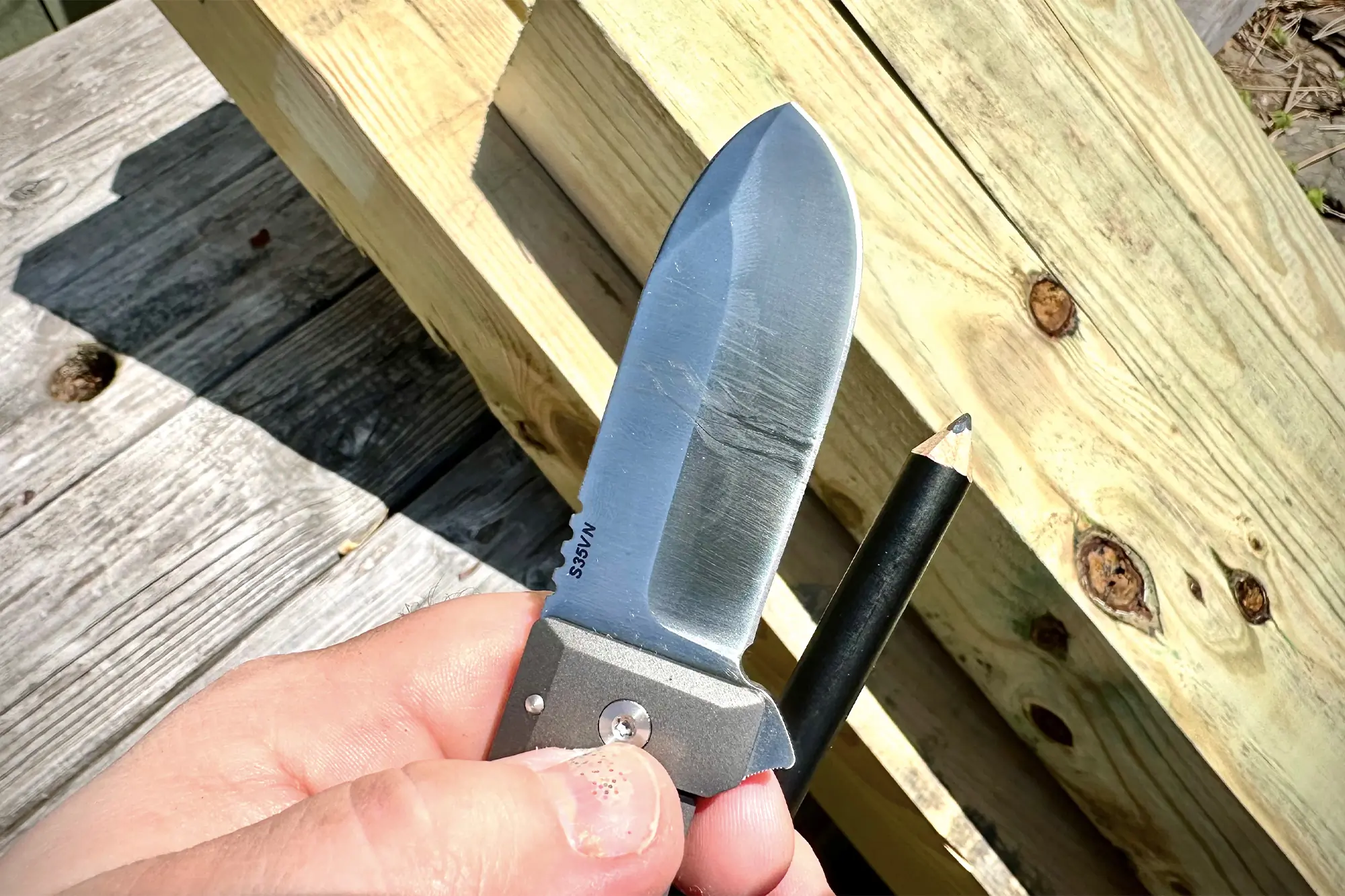 man holding wesn allman knife and sharp pen