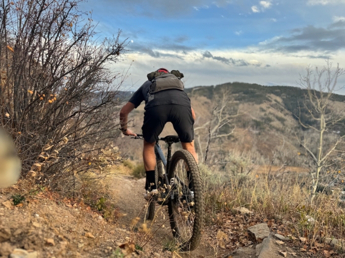 a man riding a mountain bike downhill.