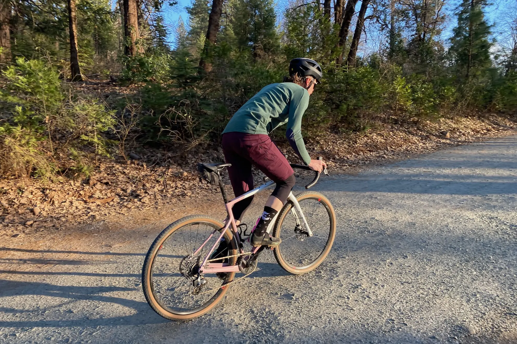 Climbing up a smooth gravel road while testing the Ari Shafer gravel bike