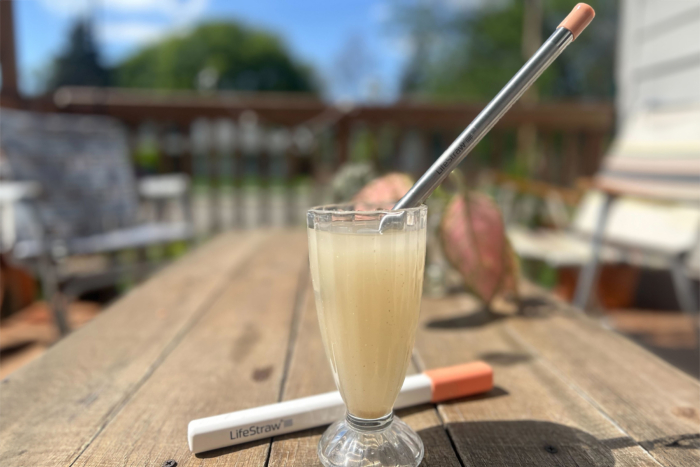 lifestraw sip filtration straw in glass on patio table