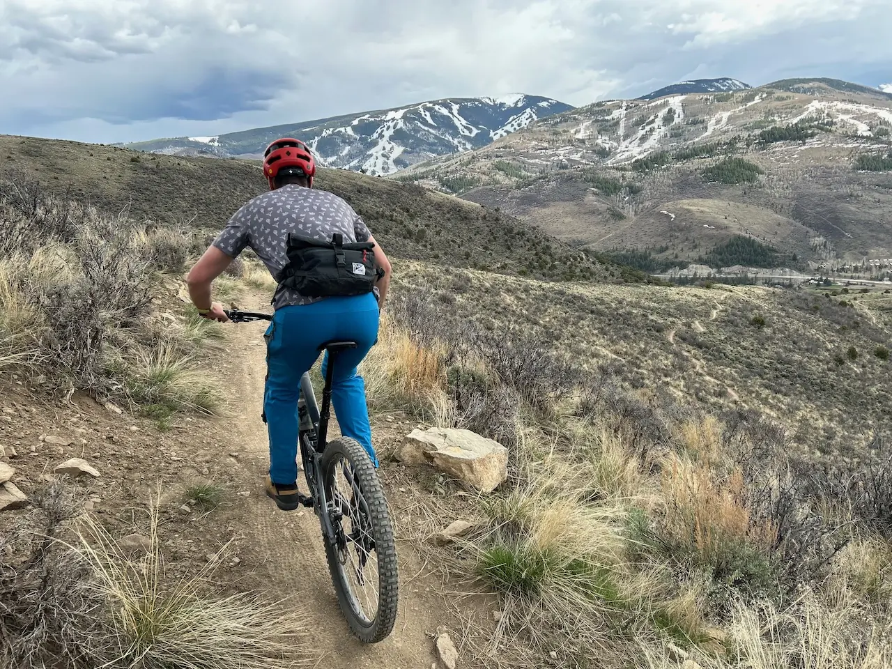 man wearing pack nw ridgeline on a mountain bike