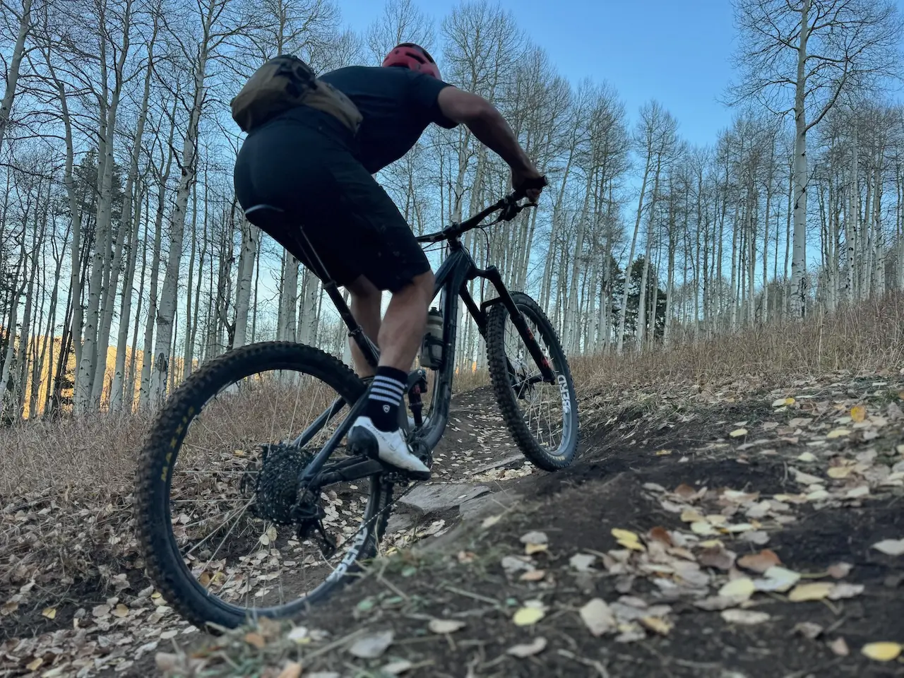 man riding mountain bike wearing hip pack