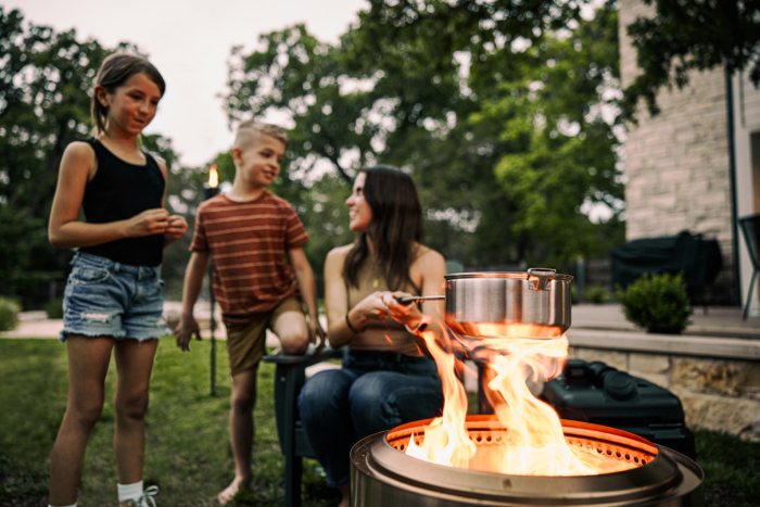 mom cooking popcorn over solo stove fire pit