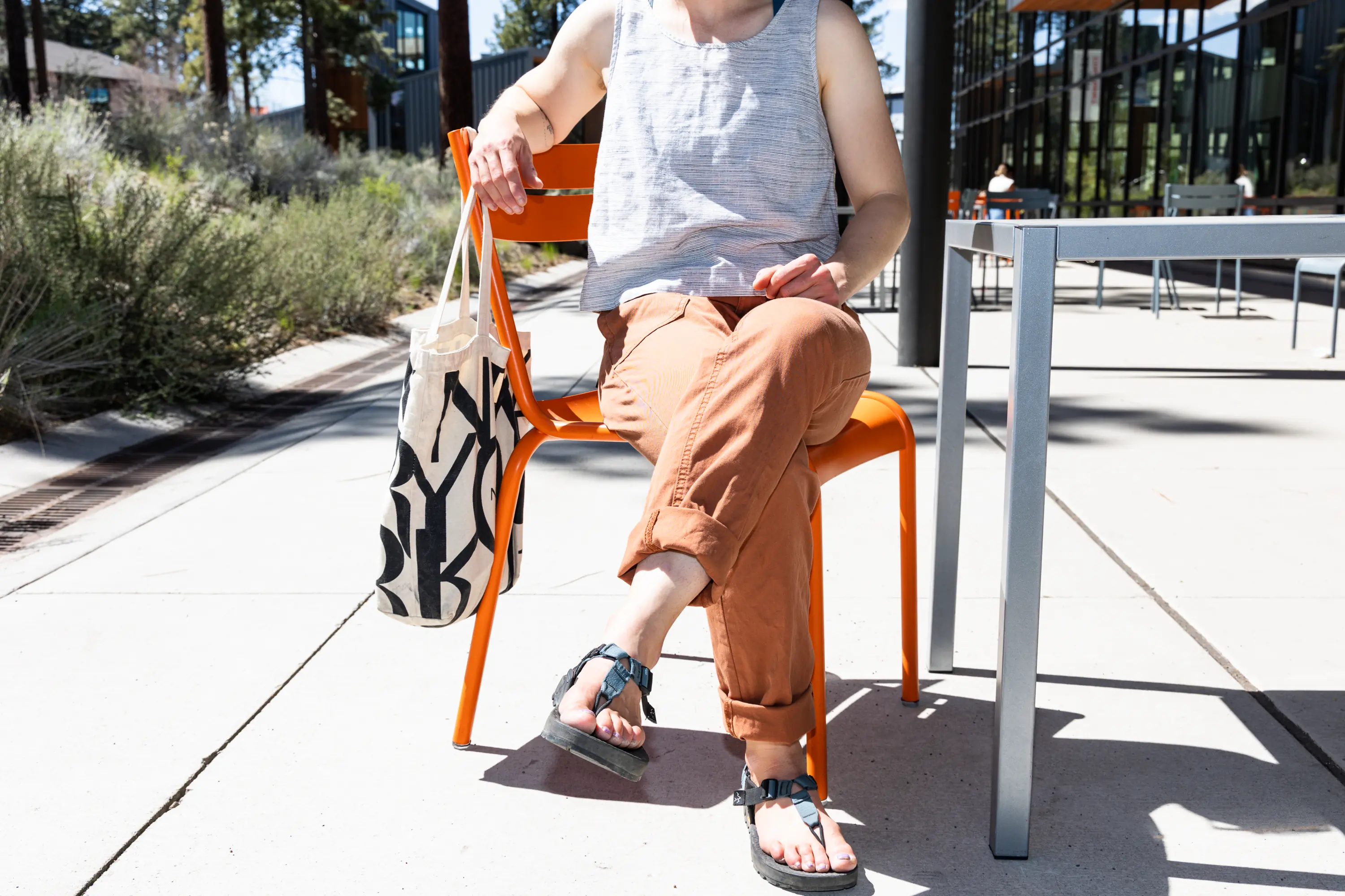 The author wearing a stylish pair of pants while sitting at a cafe