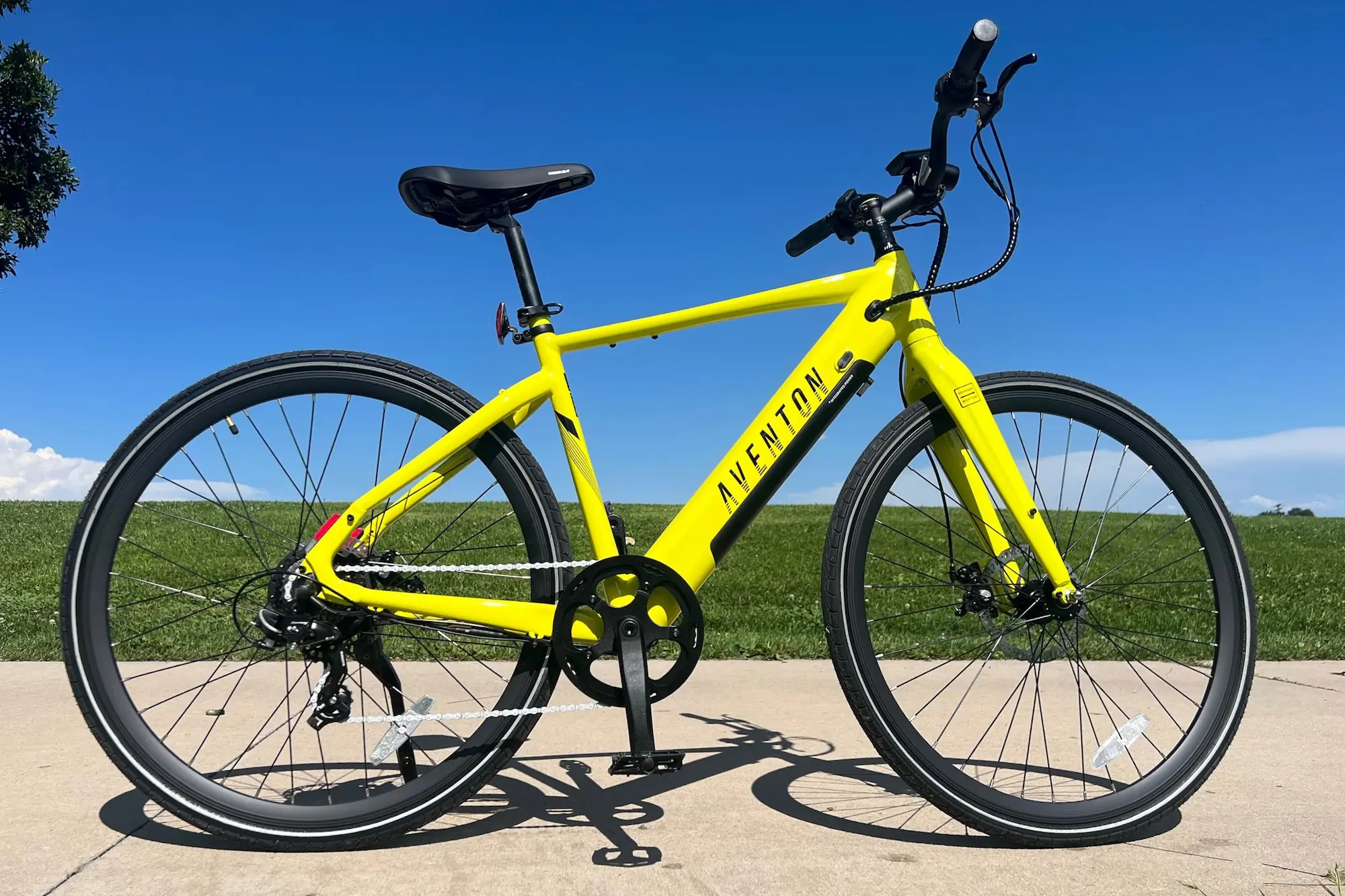 The Aventon Soltera.2 in yellow parked on a bike path