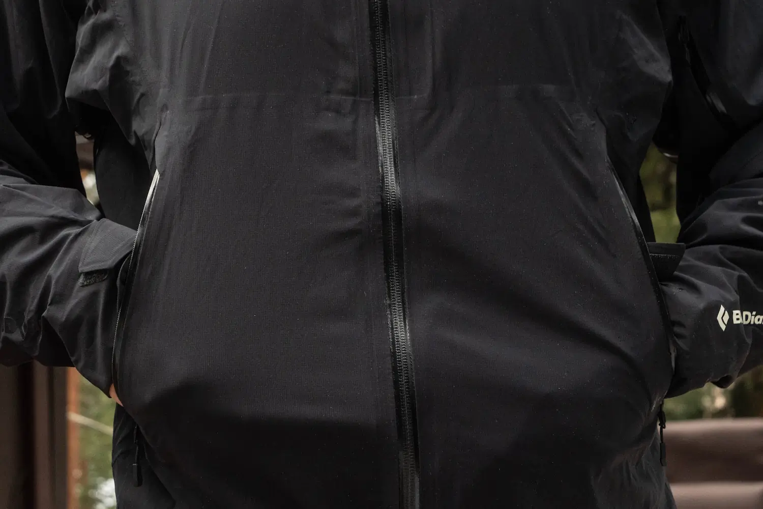 Close-up of a Black Diamond jacket showing front zippers and pockets