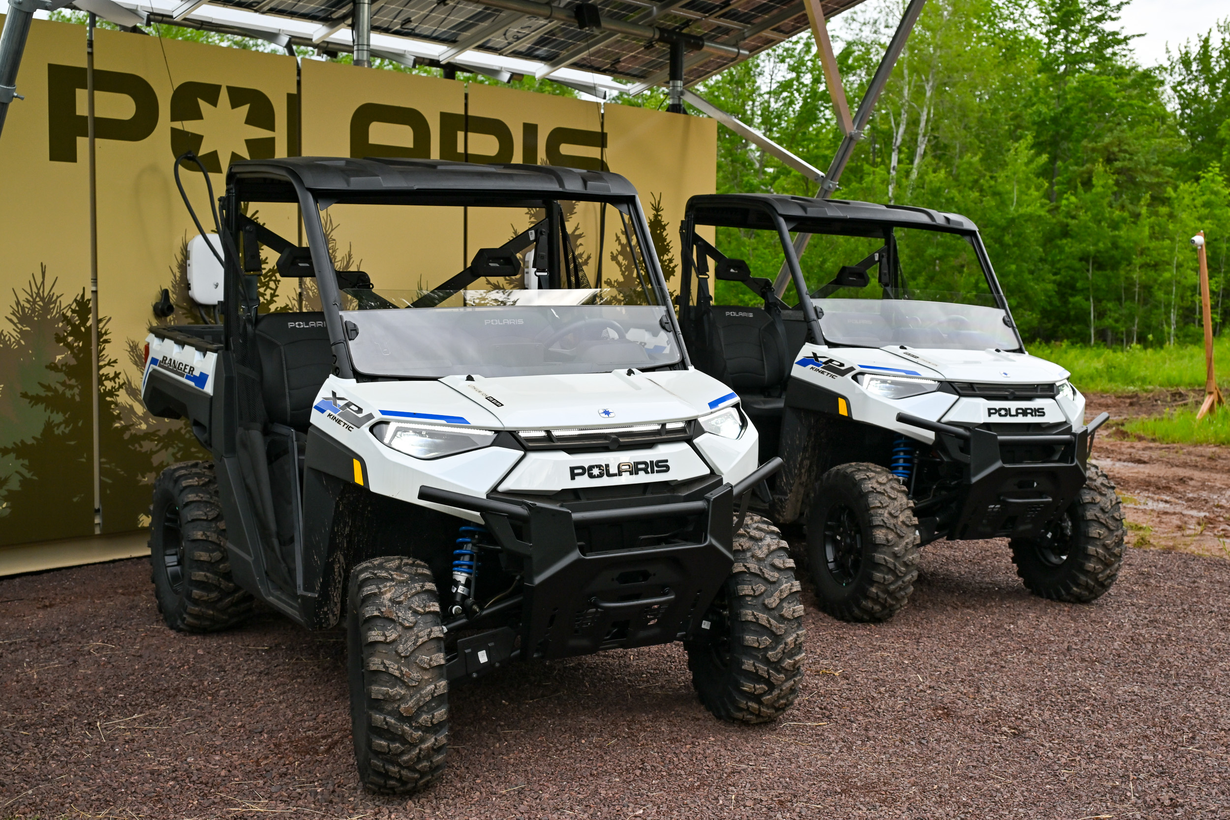 Polaris Ranger Kinetic XPs charging on a Polaris charging station